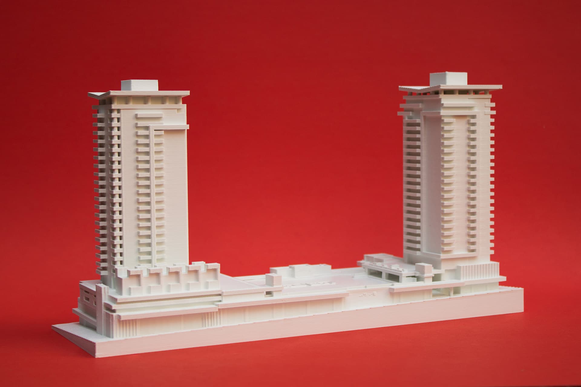 Architectural massing model with colored inserts highlighting different building zones and features