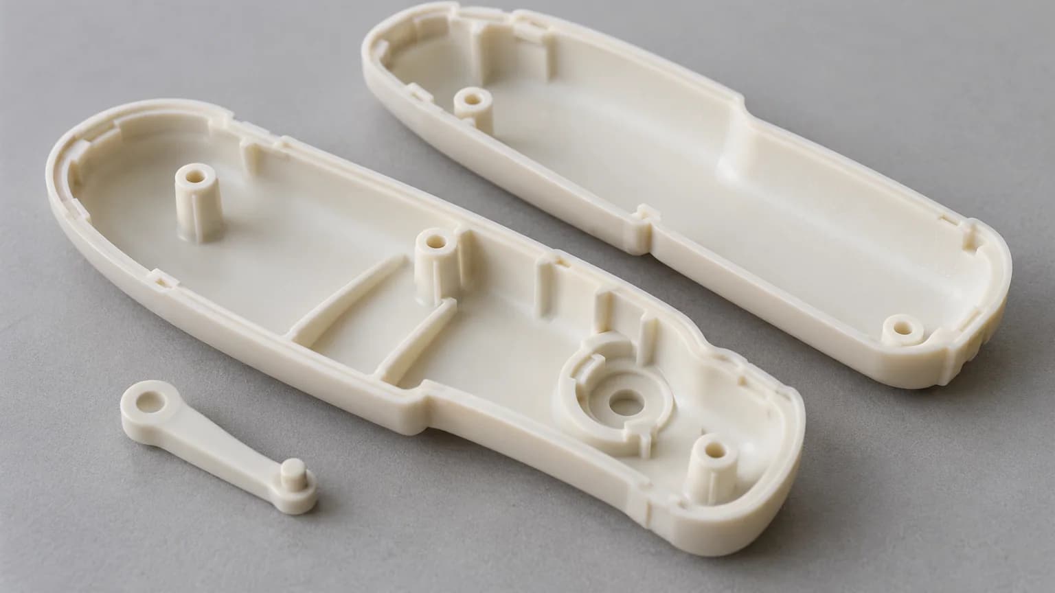Open SLA handle shells showing internal ribs, mounting bosses and a small lever seat