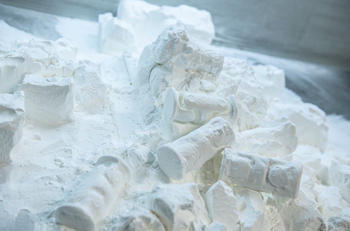 SLS 3D printed parts being removed from powder bed showing self-supporting capability