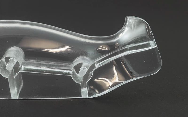 Polished clear resin 3D printed part with smooth transparent surfaces