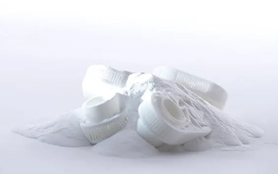 White SLS parts resting in loose powder after breakout