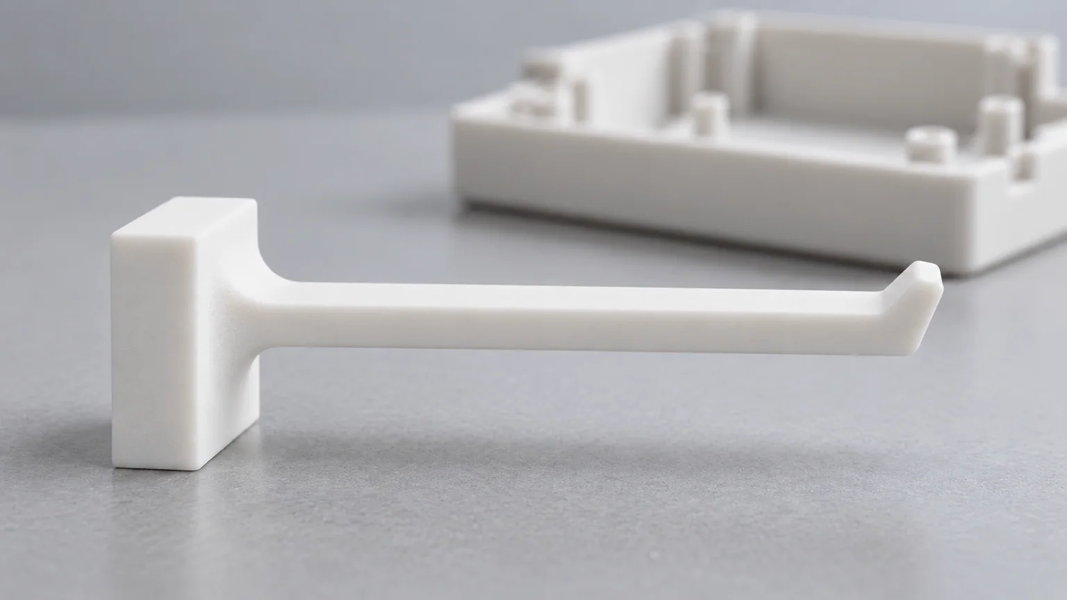 White SLS nylon clip sample showing a rounded root, free hook tip and room to flex