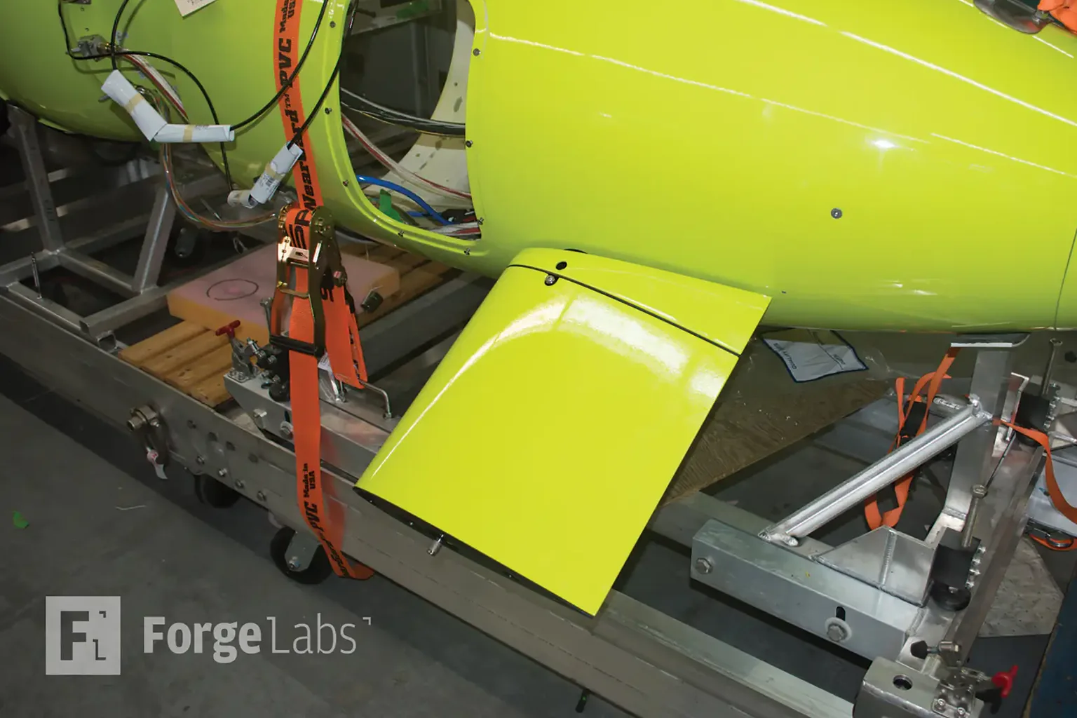 A yellow-green ASA plane extension fitted to an ISE underwater vehicle in its aluminium cradle