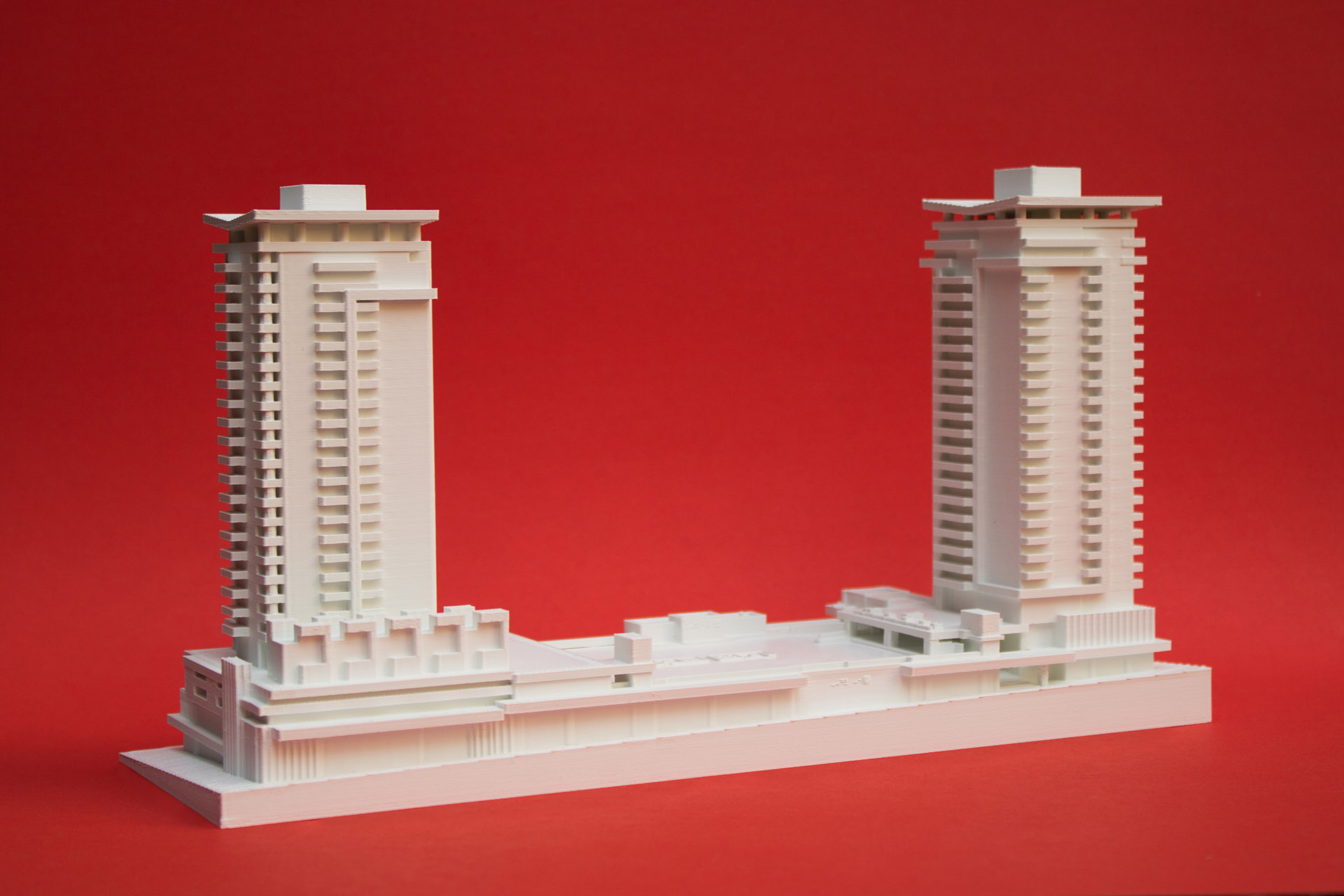 Architectural massing model with colored inserts highlighting different building zones and features